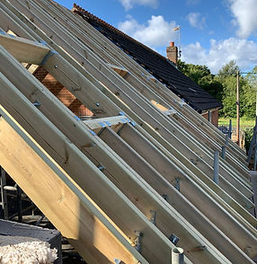 Carpentry for new roof trusses and roof windows
