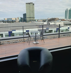 Massage chair in place on balcony of office
