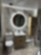 White marble bathroom tiles and backlit round mirror
