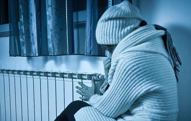 Woman cold at home with radiator issue