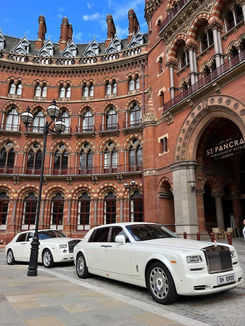 White luxury vehicles outside hotel