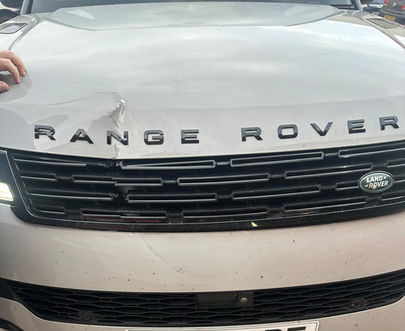 White Range Rover with damage to the bonnet
