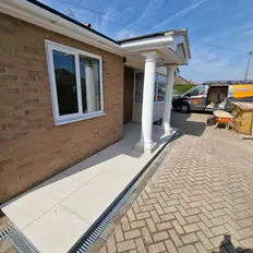 Modern brick home entrance with white pillars in Sprowston