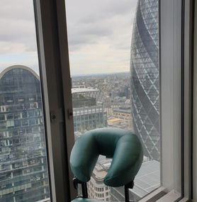 Massage chair in place in an office with view of London
