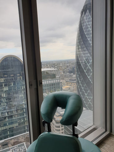 Massage chair in place in an office with view of London