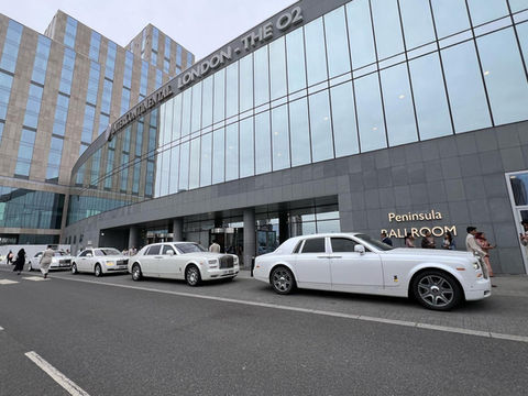 White luxury vehicles parked on road