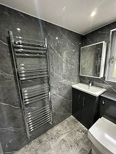 Grey marble tiles and chrome towel rail