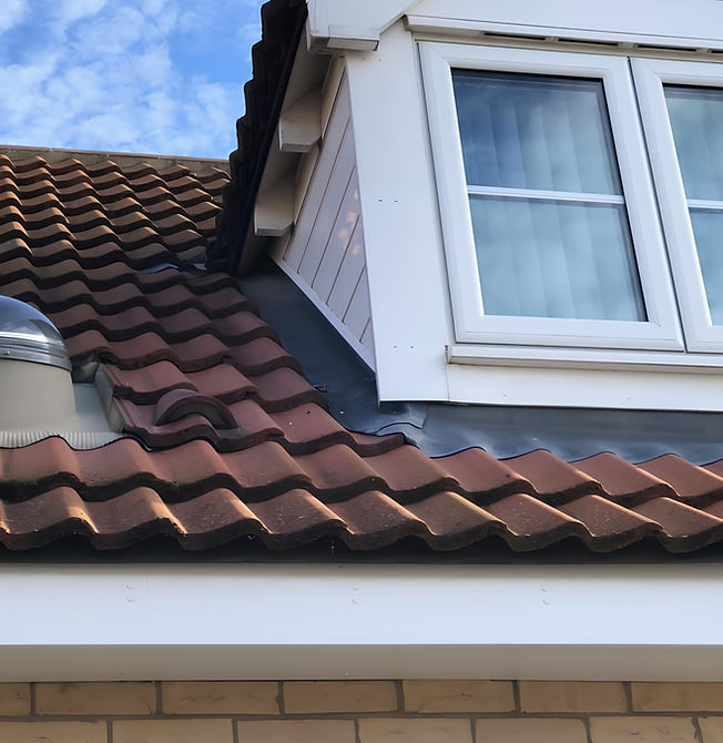 Window in red tile roof