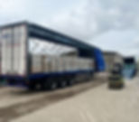 Lorry being unpacked outside warehouse facility