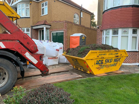 Skip parked outside house