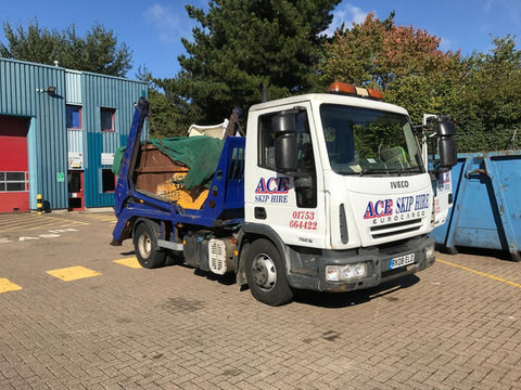 Skip lorry at work
