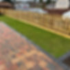 Newly installed picket fence in garden