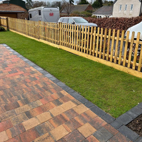 Newly installed picket fence in garden