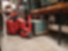 Fork lift truck and driver in warehouse