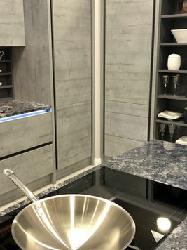Newly installed grey kitchen with wine rack and shelving