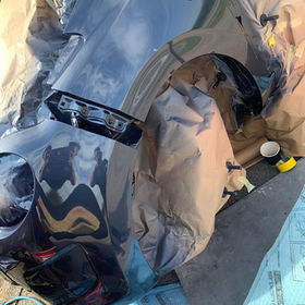 Spraying a car's wheel arch