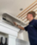 Air con engineer installing unit