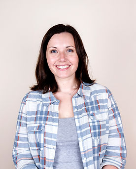 Smiling woman with dark hair and checked shirt