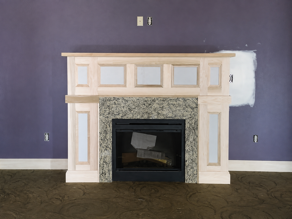 Custom white fireplace surround and mantel with decorative trim and panel molding.