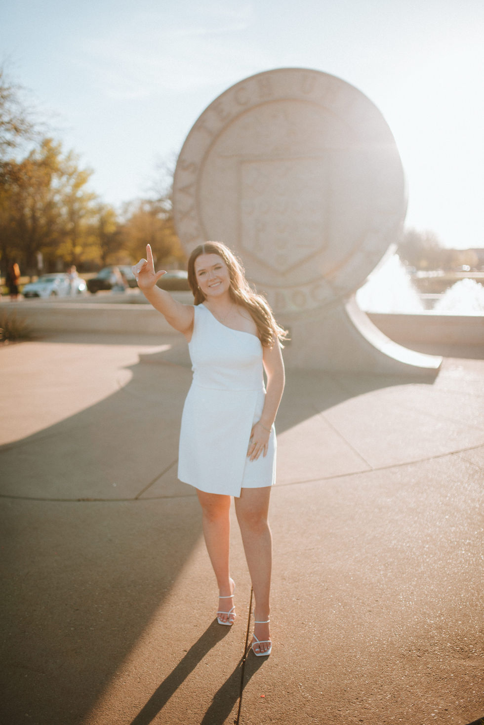 College graduation portraits at the Texas Tech University seal in Lubbock, Texas