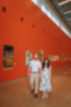 Couple inside a gallery with red walls