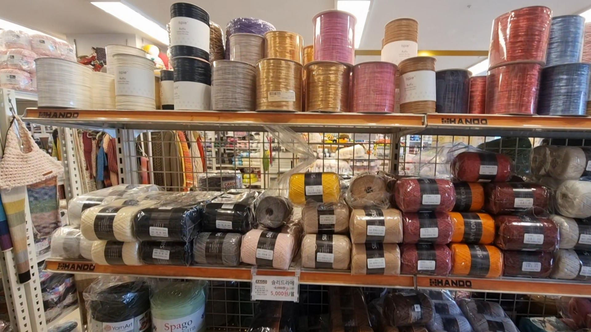 ribbon spools and more yarn on the shelf