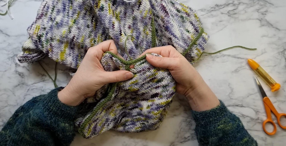Showing a hole near the edge of a sweater