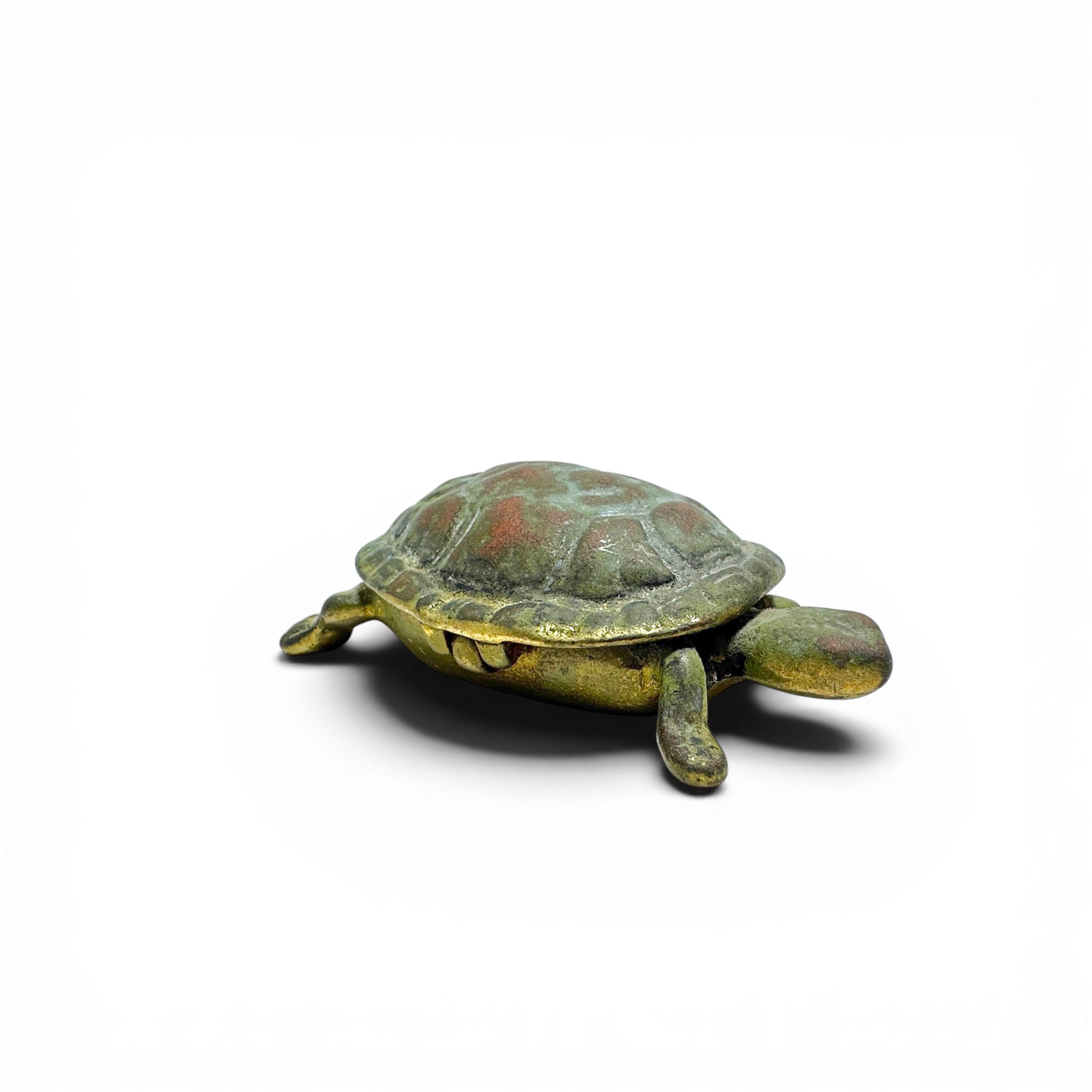 An antique brass trinket box formed as a turtle, complete with hinged shell lid.