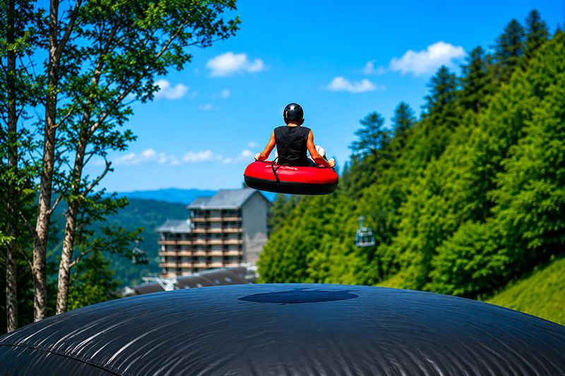 Tubing tube landing on an orange 4 Experience airbag