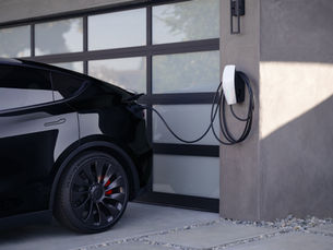 Tesla Universal Wall Connector hardwired installation in a residential garage showing professional EV charging setup for faster and safer Level 2 charging.