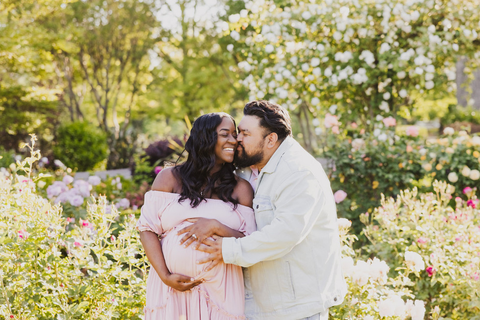 black and hispanic pregnant couple in Sacramento rose garden