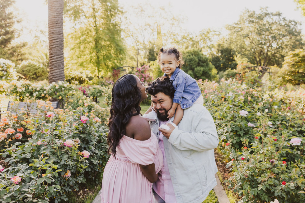 black and hispanic family in rose garden in sacramento rose garden