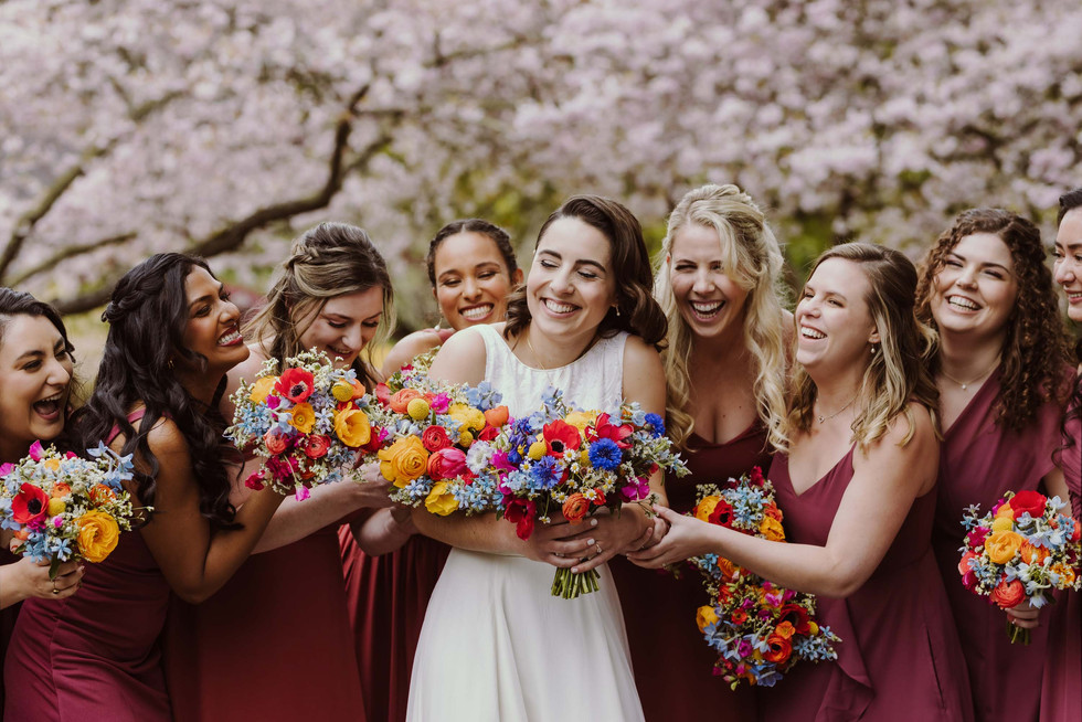 Bridemaids under cherry blossoms at spring wedding at the Brazilian Room in Berkeley, CA