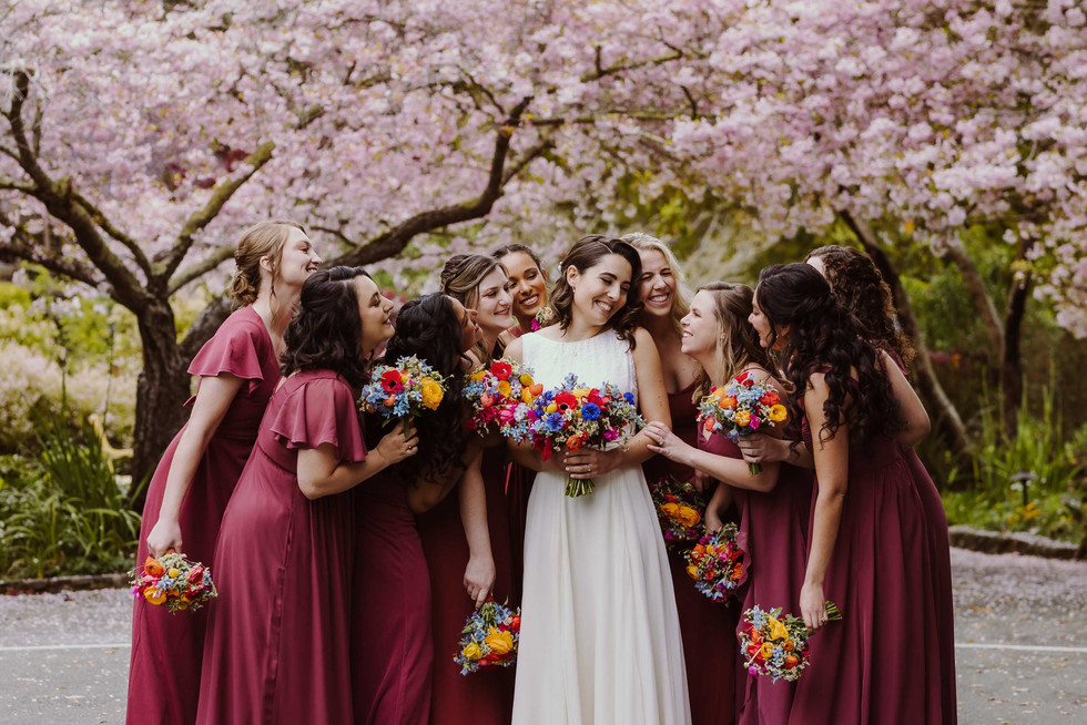 Bridemaids under cherry blossoms at spring wedding at the Brazilian Room in Berkeley, CA