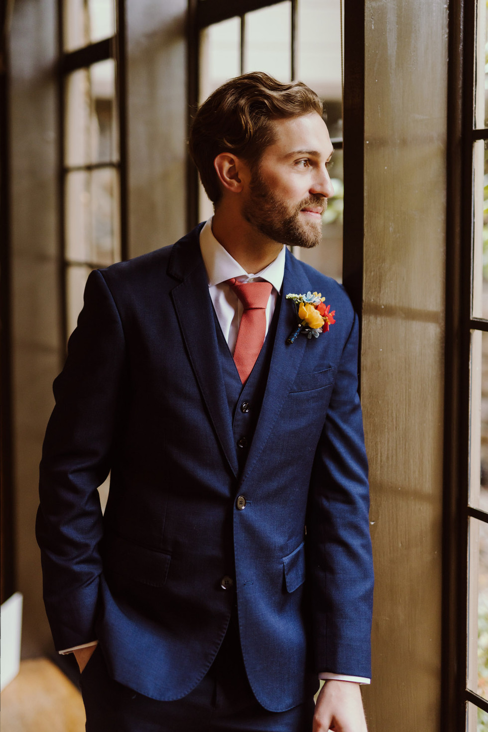 Groom looking out window at the Brazilian Room in Berkeley, CA