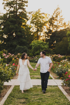 engaged couple having fun in the rose garden