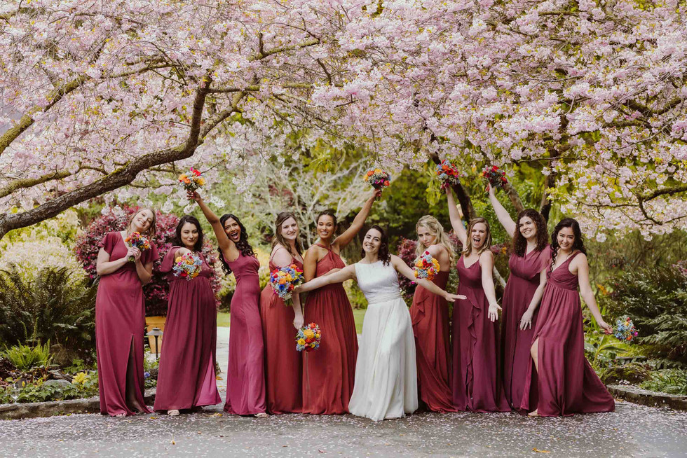 Bridemaids under cherry blossoms at spring wedding at the Brazilian Room in Berkeley, CA