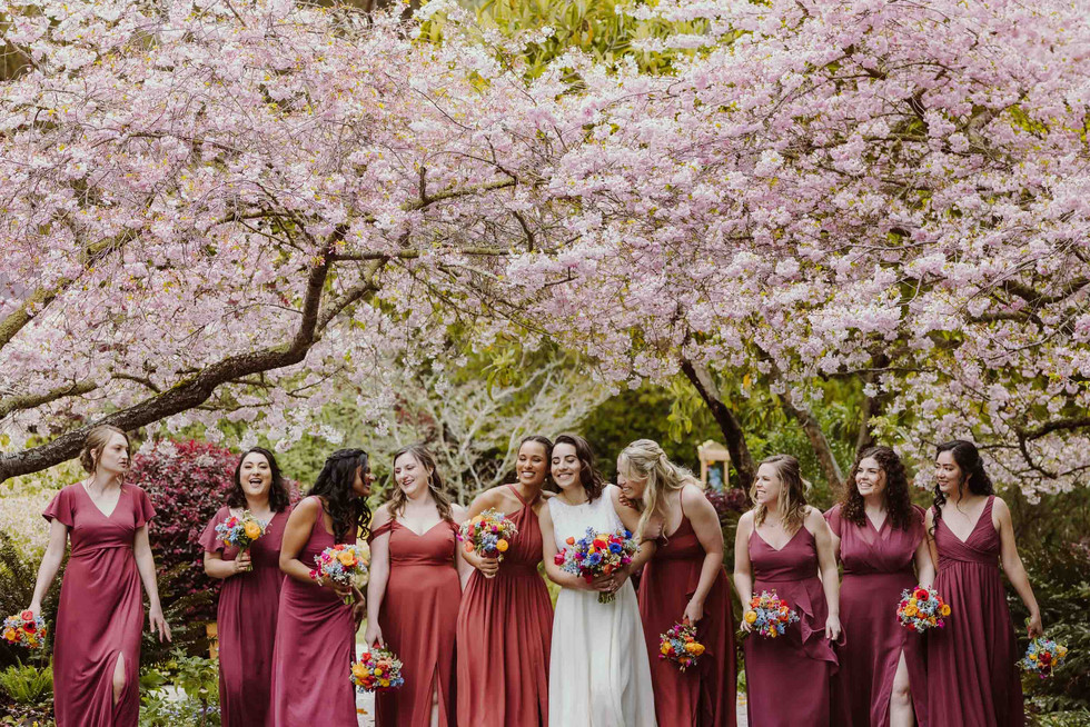 Bridemaids under cherry blossoms at spring wedding at the Brazilian Room in Berkeley, CA