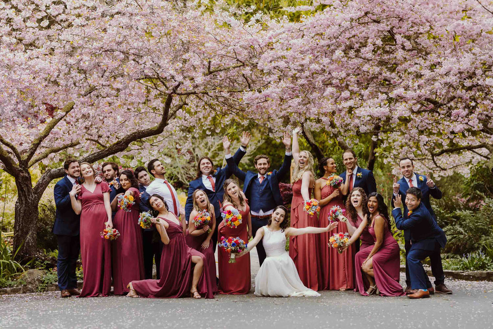 Groomsmen under cherry blossoms at spring wedding at the Brazilian Room in Berkeley, CA