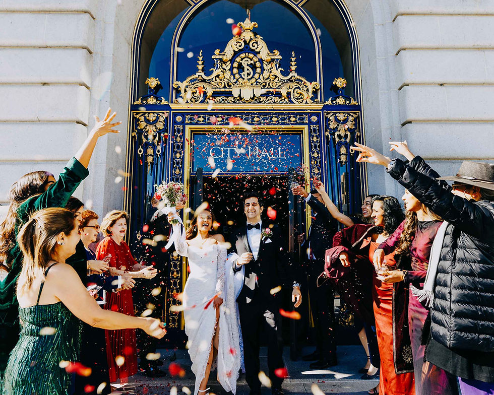 Family throwing flowers on couple