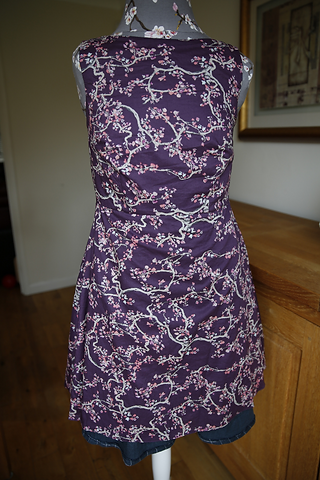 Front view of the Lilou Dress inside out on a mannequin showing the full lining in maroon floral fabric