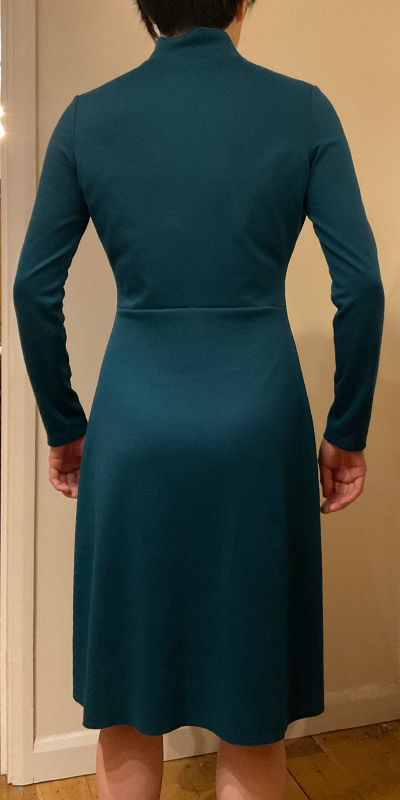 Back view of Tilly and the Buttons Freya Dress with back waistline seam to fit swayback, with arms raised showing drag lines disappearing