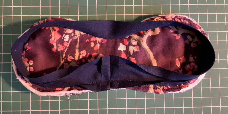 Fifi eye mask with overlap of binding sewn together, seam trimmed and pressed