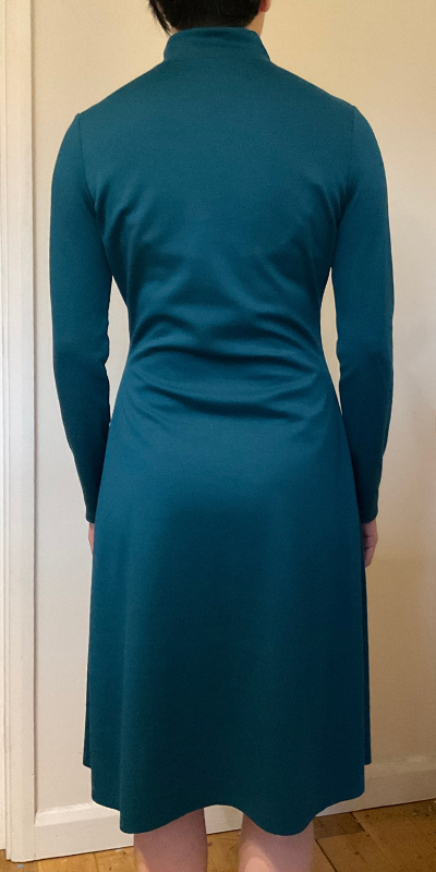 Front view of Tilly and the Buttons Freya Dress in teal green ponte knit showing drag lines and excess fabric at back waistline