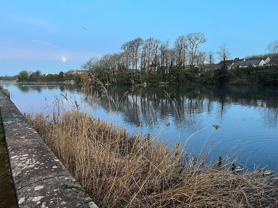 Sunrise view of Pembroke Mill Pond showing a full moon