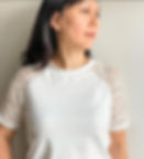 Sammieseams in a white jersey top with white lace sleeves