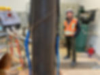 Technician with extracted well casing inside pump house