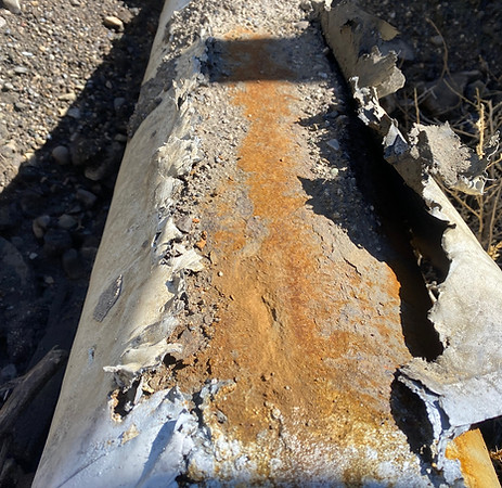 External corrosion and failed tape wrap coating observed during excavation along the slag/slurry pipeline corridor.