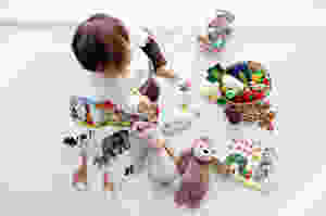 toddler on floor with toys