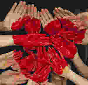 hands painted in red creating a heart